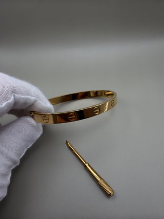 Pulsera rígida dorada con destornillador