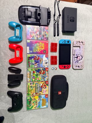 Nintendo Switch con 6 juegos y accesorios y caja.
