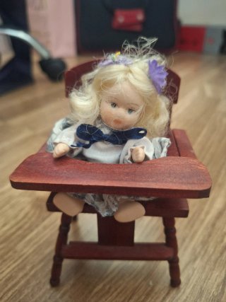 Muñeca de Porcelana en Silla de Madera