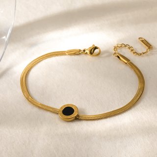 Pulsera dorada con detalle central negro