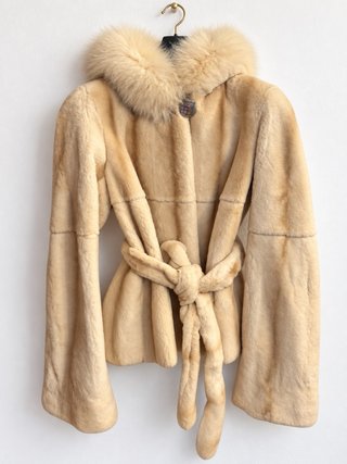 Chaquetón de piel corto con capucha de pelo.
