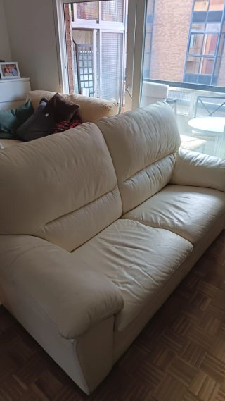 Sofá de 3 plazas de piel beige.