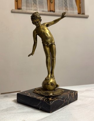 Scultura antica ragazzo su globo